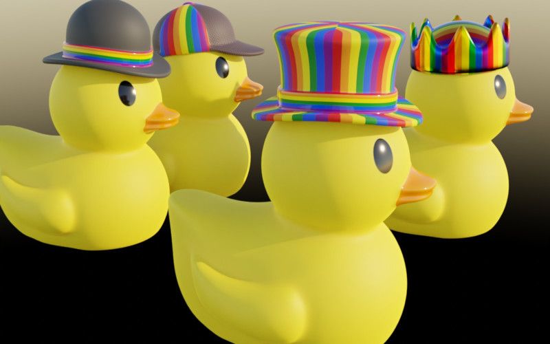 Simple rubber duckies wearing hats with LGBTQ+ rainbow colors, one wearing a bowler hat, one wearing a deerstalker, one wearing a crown, and the one in the foreground is wearing a top hat.