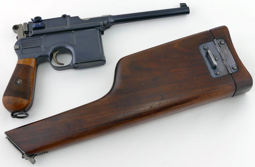 A Mauser C96 pistol with its detachable stock holster below it