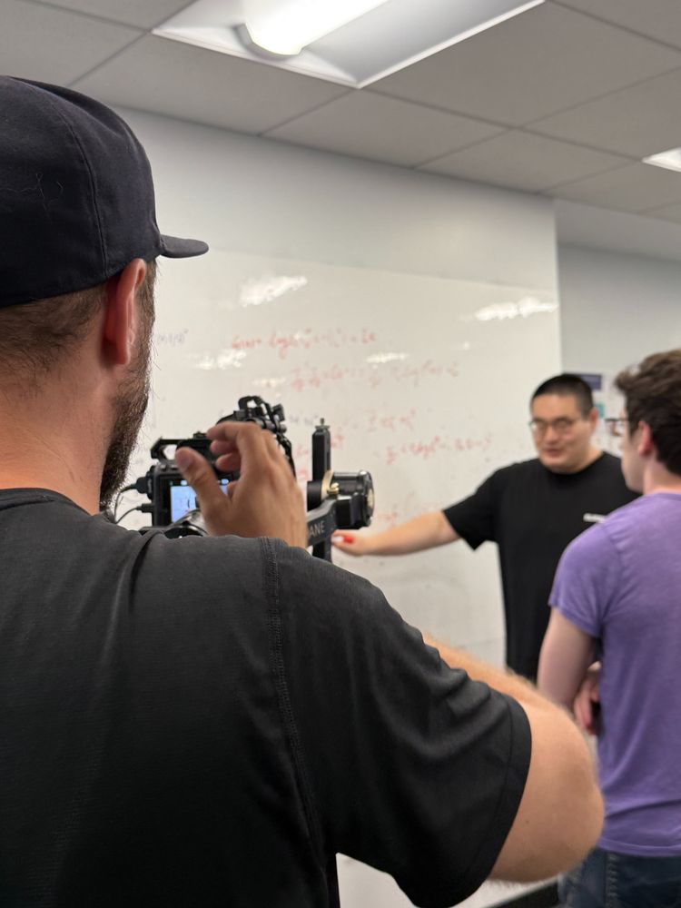 A person filming two people
