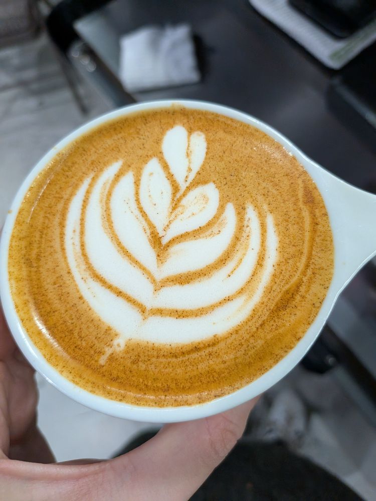 a vanilla honey cinnamon cappuccino with latte art with 5 stacks!