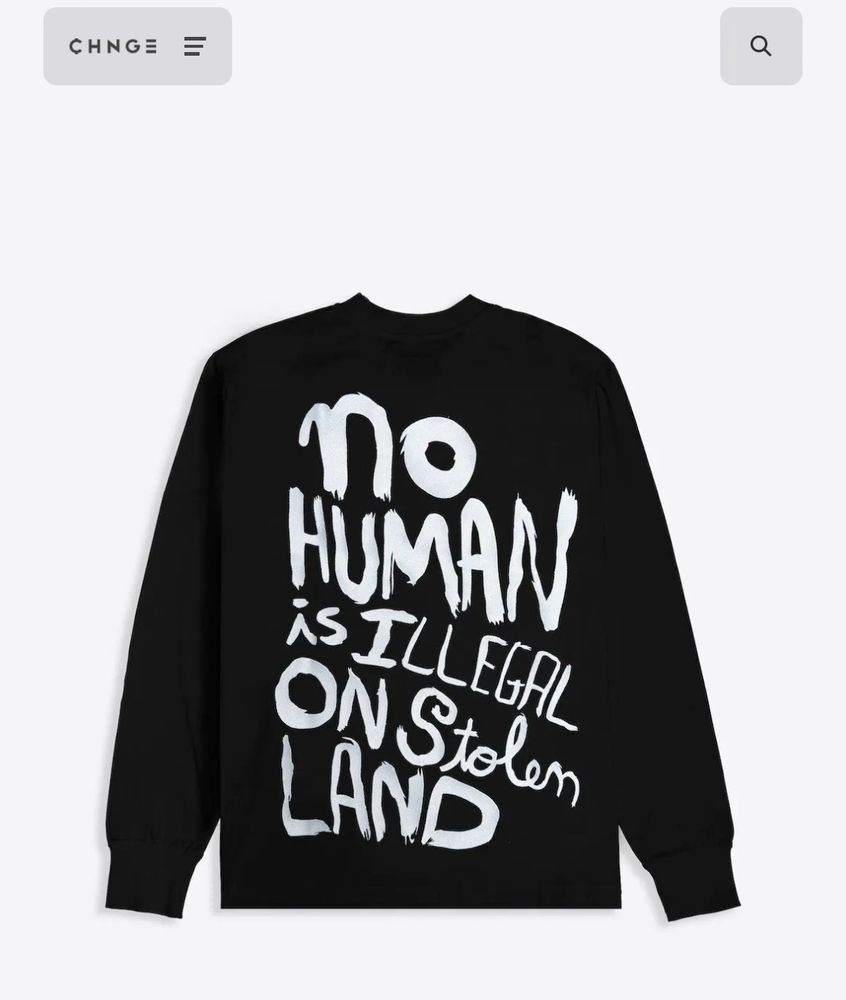 Long sleeve black shirt says NO HUMAN IS ILLEGAL ON STOLEN LAND.