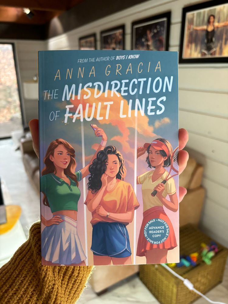 A book being held up by a person.