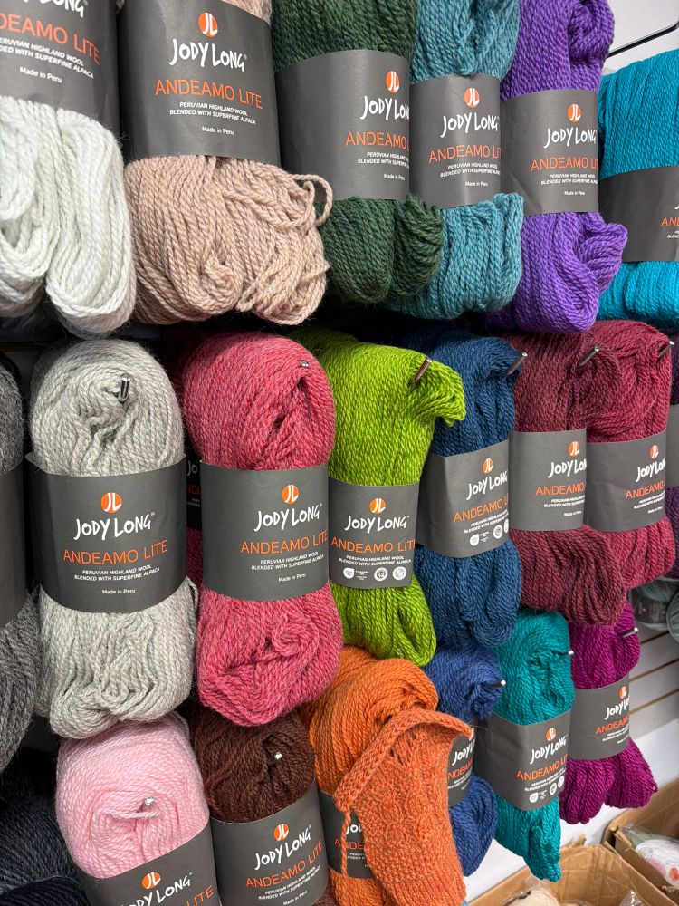 A bunch of colorful, cuddly looking hanks of yarn.