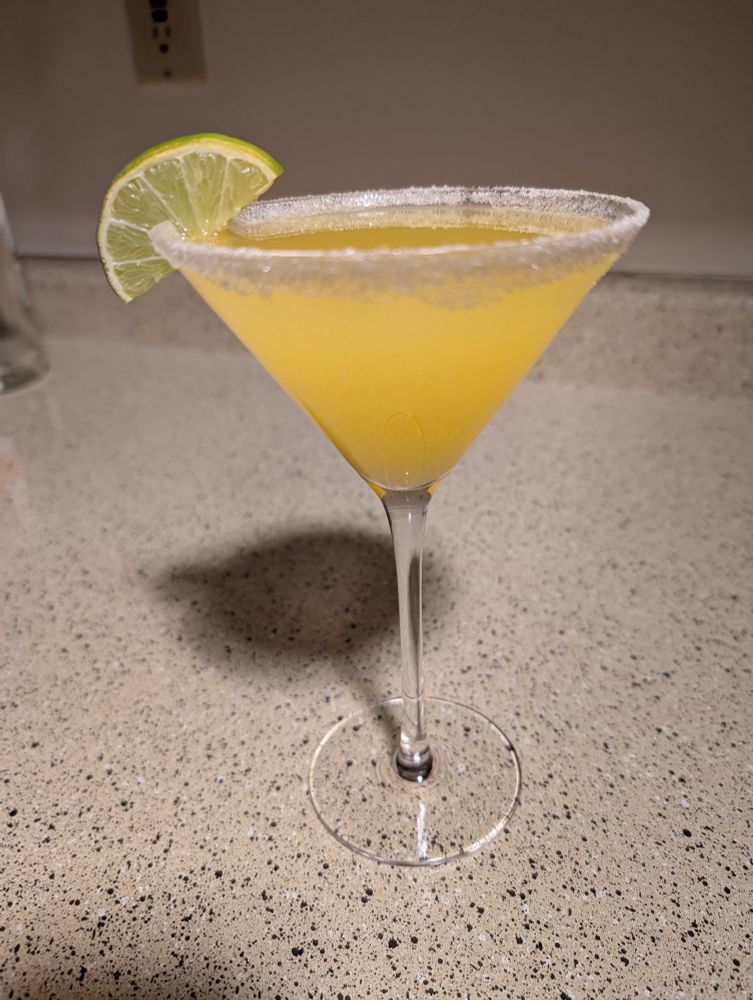 mango martini with sugar rim and a lime slice