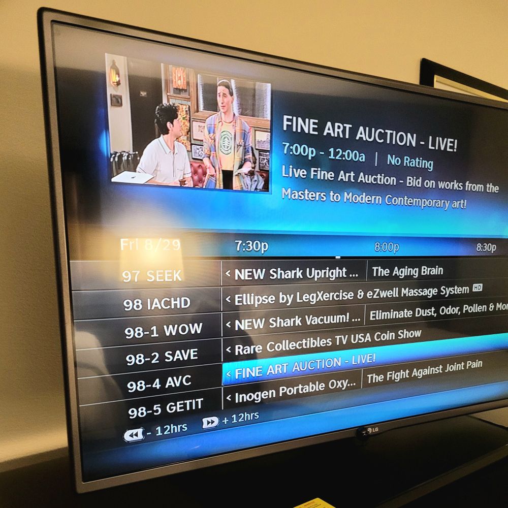 Hotel TV guide showing an infomercial for a Shark vacuum