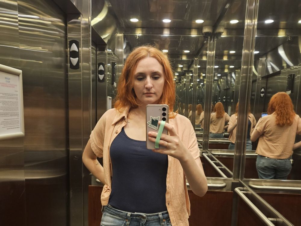 Me, a different Ellie wearing a pink shirt and navy tank top, reminiscent of Dr Ellie Sattler's outfit in Jurassic Park 