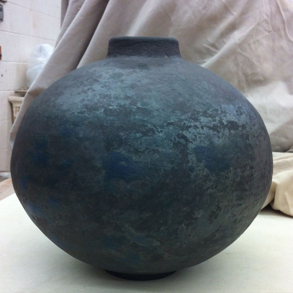 My version of a moon jar. It's a round stoneware form with a short neck. The surface is mottled dark gray with deep blue spots. 