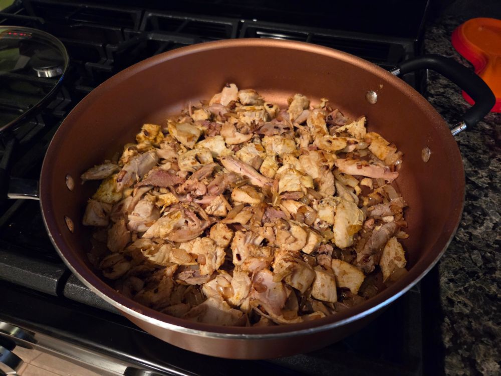 A saute pan filled with turkey, a mixture of dark and breast meat, ready for Butter Chicken! Sauté in onions and butter for about 5 minutes...