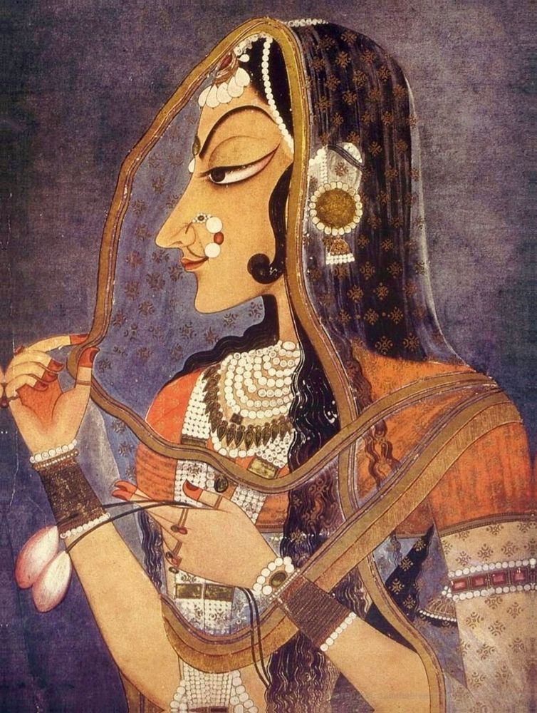 The legendary beauty of Bani Thani, a one-of-a-kind concubine of Raja Sawant Singh of Kishangarh (who reigned from 1748-1757), was most famously captured by Indian artist and poet Nihâl Chand in this iconic painting at the National Museum in New Delhi. Chand’s depiction combined the aesthetics of side-profile Mughal portraiture with the exaggerated features of Indian statuary. It is suggested that the enlarged eyes of his portrait may have taken inspiration from the symbolic importance of eyes in Indian poetry and ritual. The distinctive features of Chand’s rendering of Bani Thani can be seen on Kishangarh paintings throughout the remainder of the 18th century, often transfigured into the Hindu deity Radha.

Bani Thani is depicted with a serene and elegant demeanor showcasing detailed ornamentation, including jewelry and clothing, reflecting the Rajput royal style. She has elegant and graceful features, rather stylized, including arched eyebrows, lotus-like elongated eyes and pointed chin. Born as Vishnupriya, she was a singer employed by the stepmother of Raja Sawant Singh in Kishangarh and he was drawn to Vishnupriya because of her beauty and singing. She came to be known as “Bani Thani” — which loosely means “the decked out lady” — because of the exquisite jewelry and makeup that she adorned herself with after becoming queen.

Both lovers died in the 1760s. Today, they have twin chhatris (elevated, dome-shaped memorials) dedicated to them near the Nagari Kunj temple in Vrindavan.

Due to its iconic status and captivating beauty, this painting has been hailed by some as the “Mona Lisa of India.” It was featured on an Indian postage stamp issued May 5, 1973.