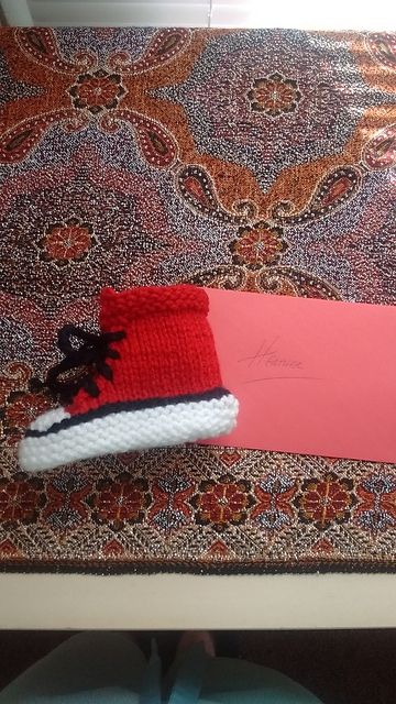 Red and white baby chucks booties with black laces.