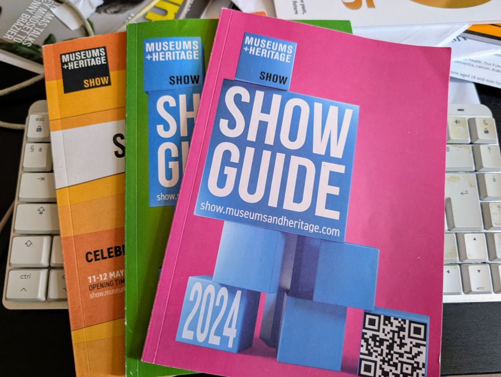 Three copies of the M+H Show guide, from 2022 to 2024