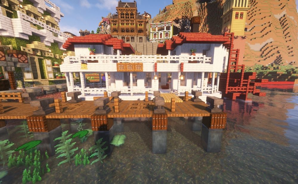 View from the side of the dock and the ferry. We can see there are two red roofs, and the old school ferry propeller is also red. 