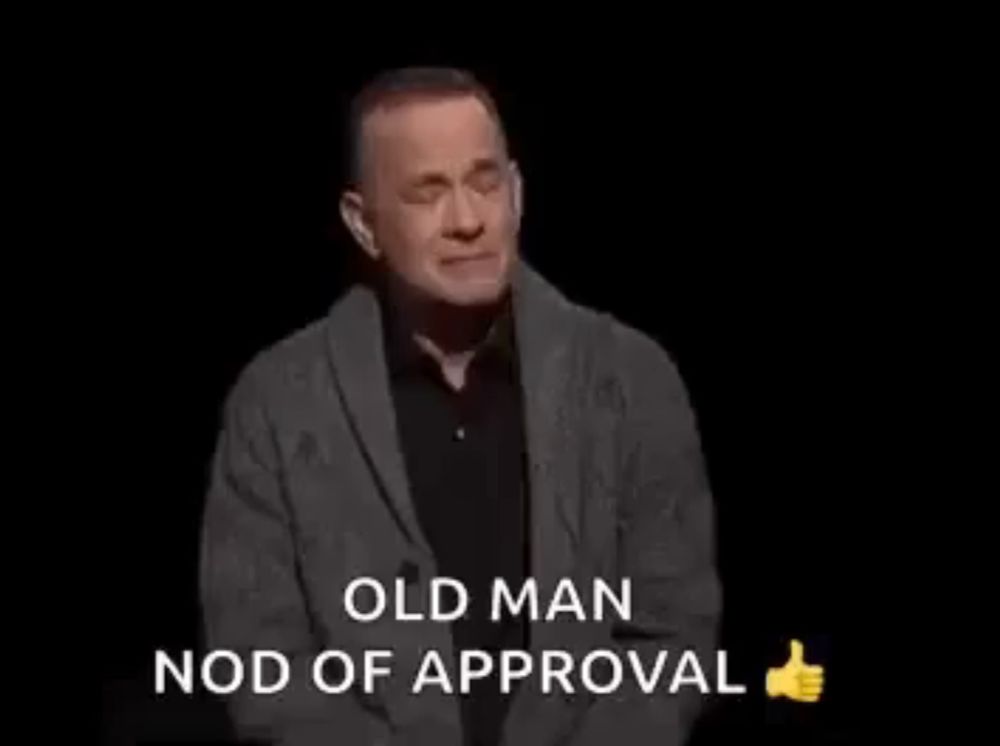 a man is giving a thumbs up and saying `` old man nod of approval '' on a black background .