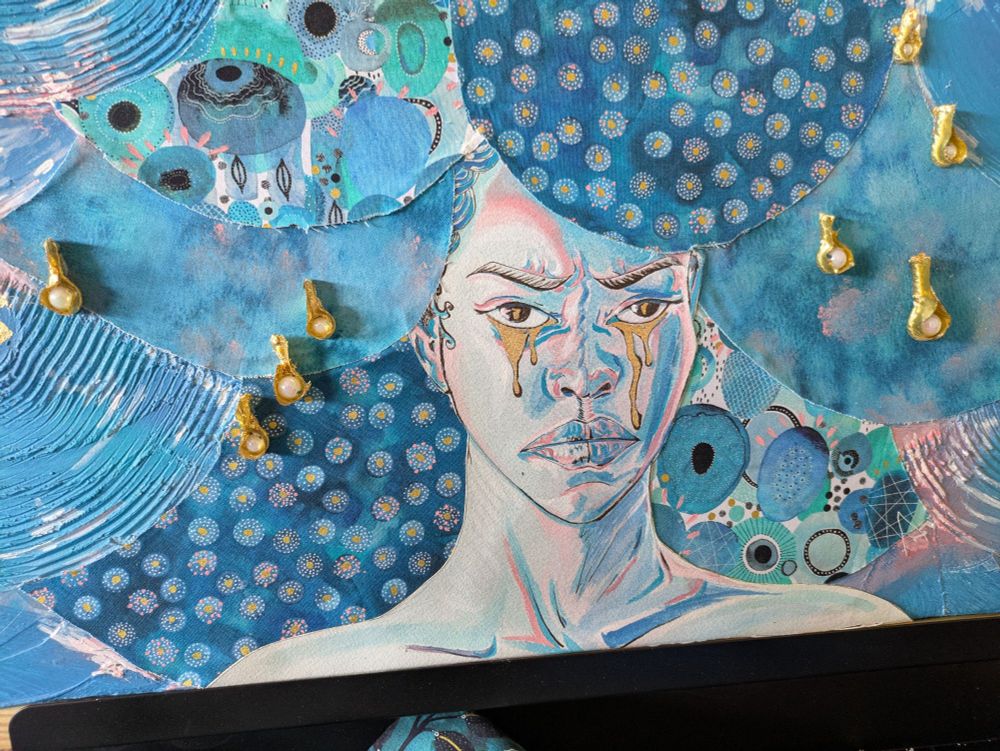 Blue textured canvas with gold raindrops and a woman crying gold tears. Patterned fabric for hair. Front view.