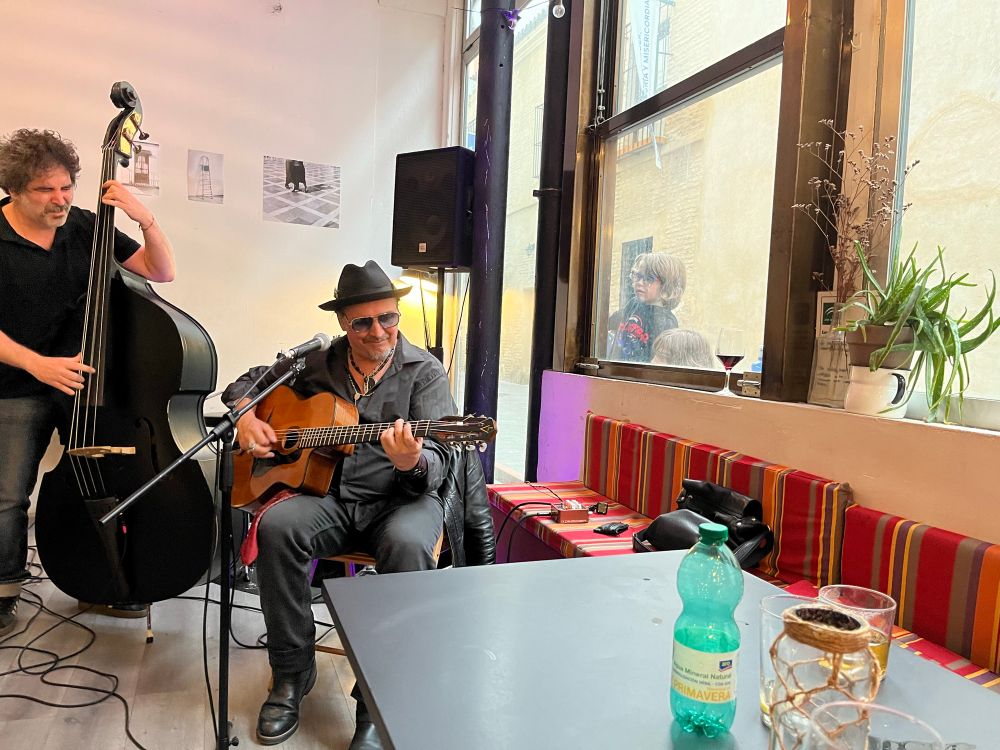 Kids peeking through the window while enjoying a Gypsy jazz performance. 