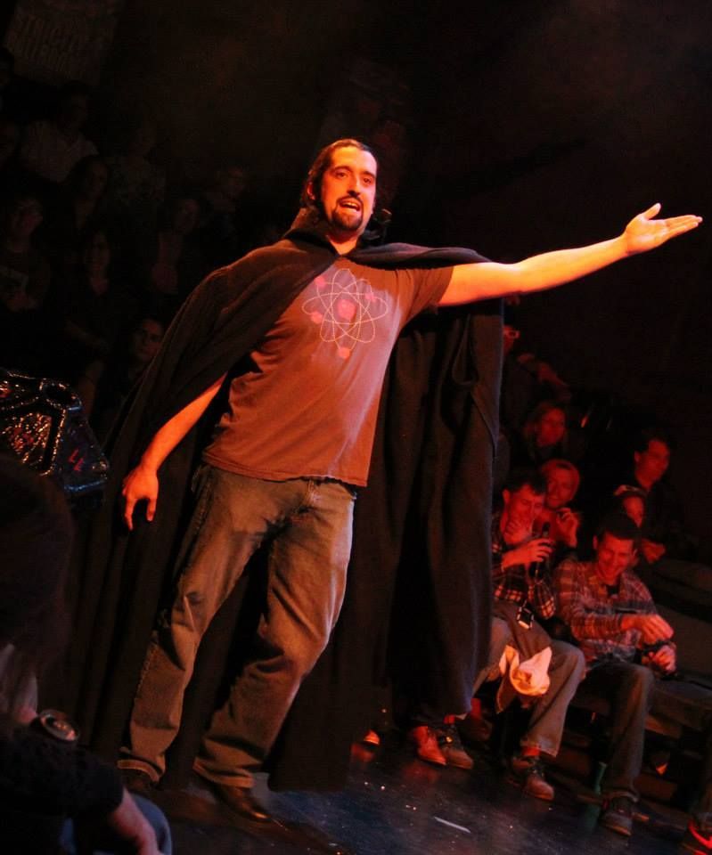 Lou posing as a dungeon master in an improv theater show. 