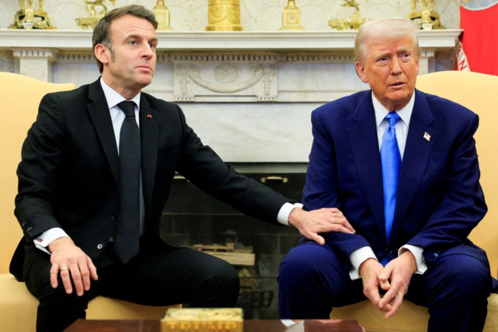 Putting his hand on President Donald Trump’s arm, French President Emmanuel Macron said, “We provided real money, to be clear.”