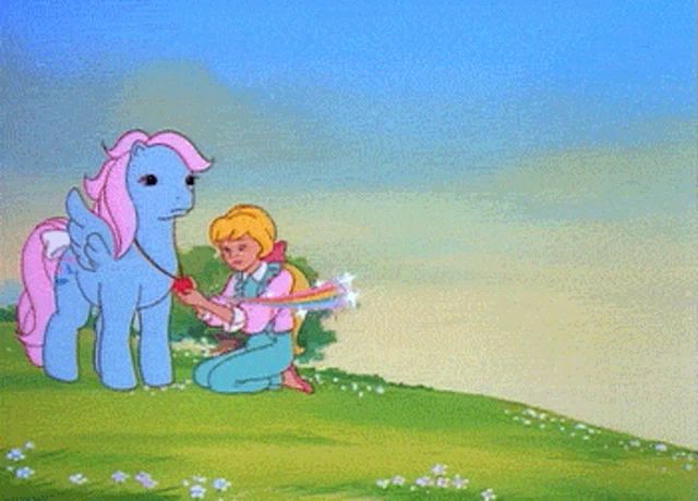 a little girl kneeling next to a pony with a rainbow behind them