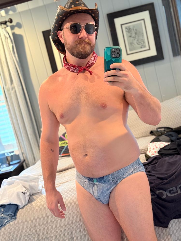 man in a denim speedo and cowboy hat