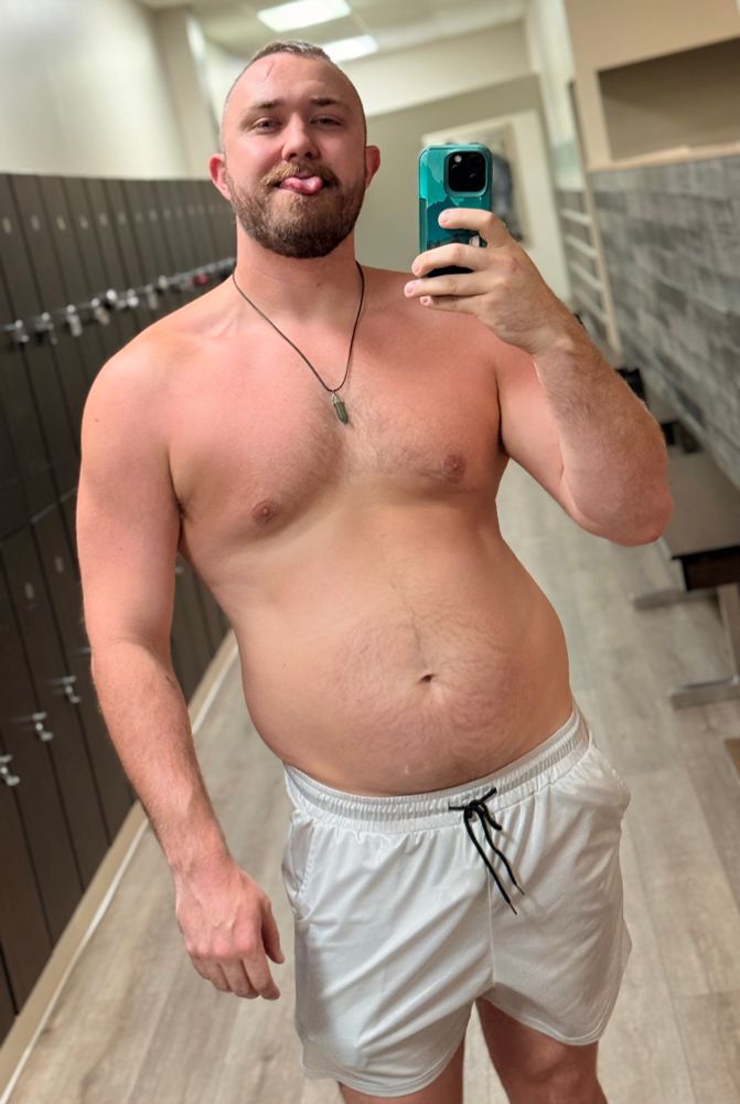 shirtless man in a locker room