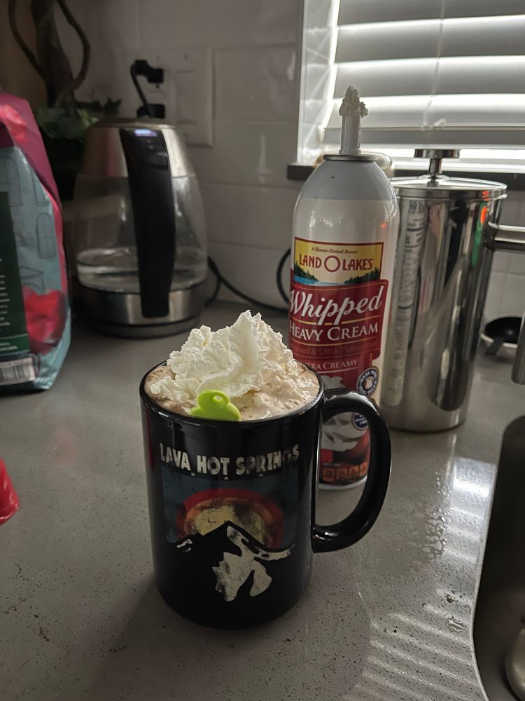 Black coffee cup with whip cream on top