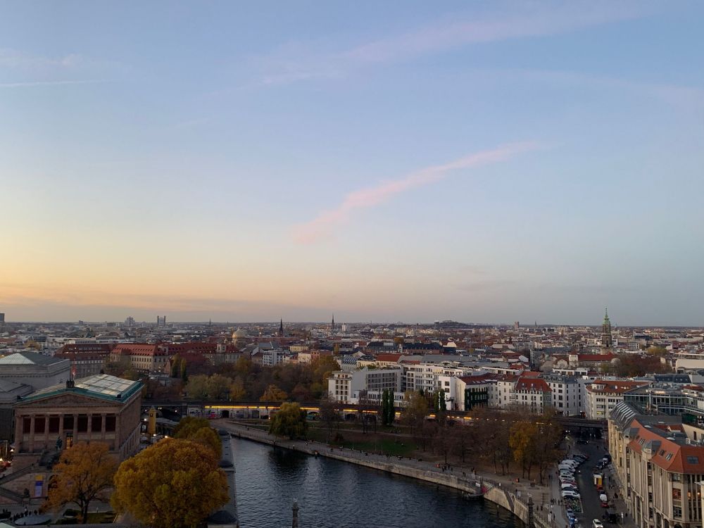 A photo looking out over the Spree in Berlin. The sky is mild blue