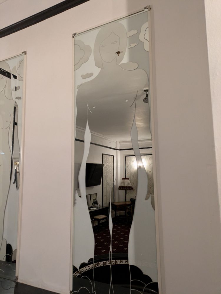 A close up of one of the naked figure mirrors