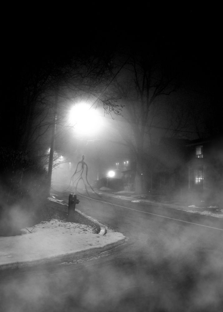 A creature walking down a foggy road