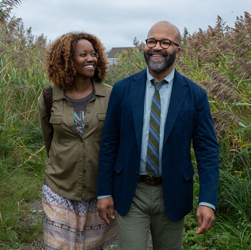 coraline (erika alexander) and thelonious "monk" ellison (jeffery wright), as a fictional couple walking throuhg a field. they both look very happy.