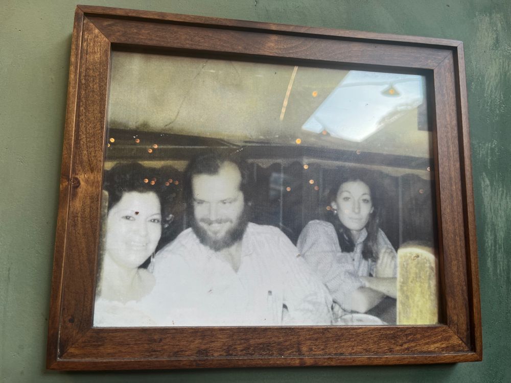 Anjelica Houston looks bored as Jack Nicholson flirts with a waitress at a Mexican restaurant 