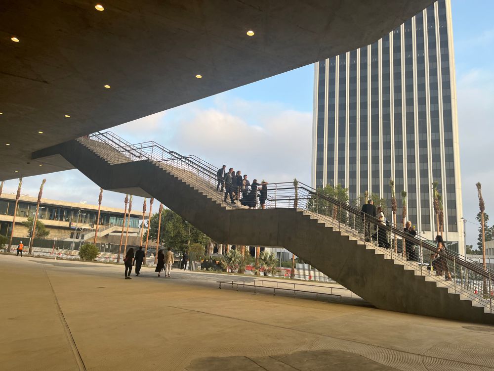 A set of floating concrete stairs leads to the second story of a museum: