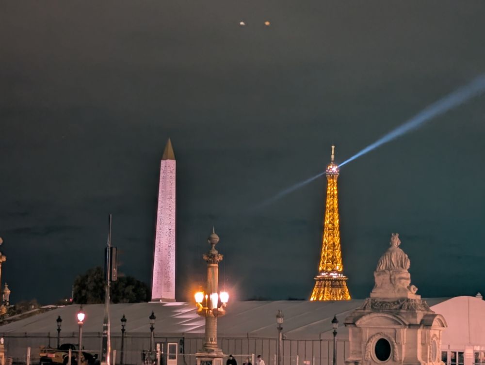 Eiffel tower at night and the Luxor obelisk in the place de la Concorde
