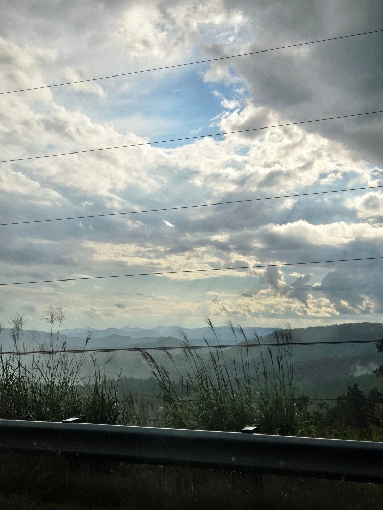 a picture of a sky right after it rains with a mountain range in the background 