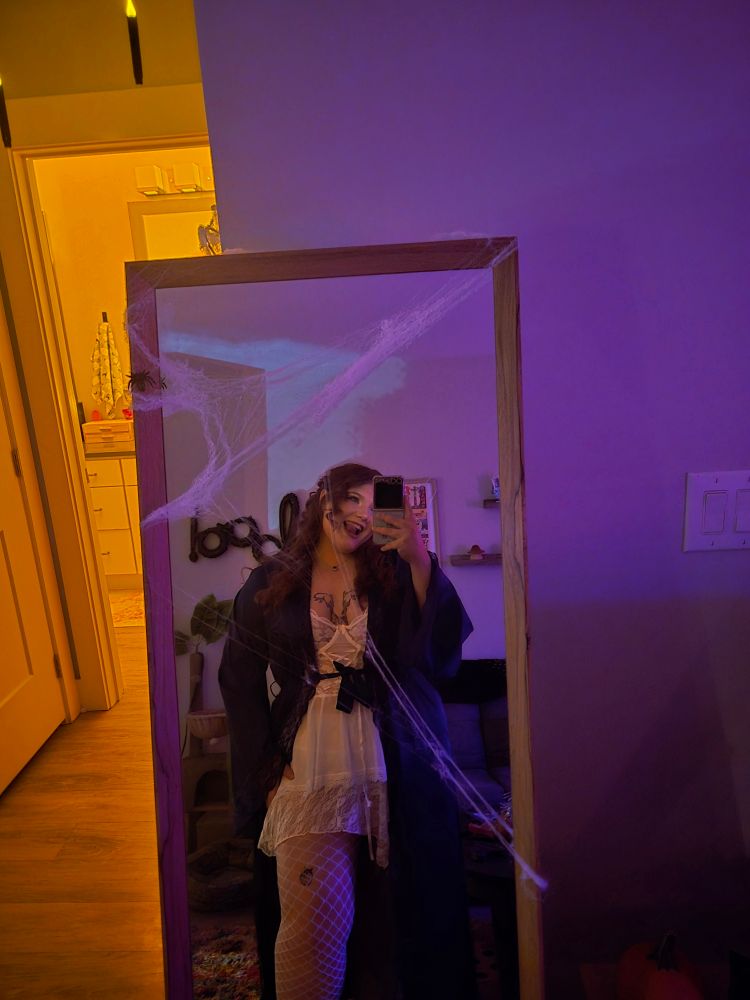 A mirror selfie with me in a lace nightgown and a navy blue robe