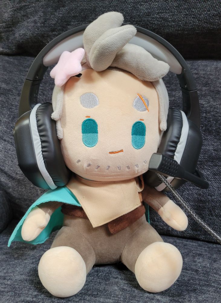 Logan plush wearing the headphones - he's a gamer