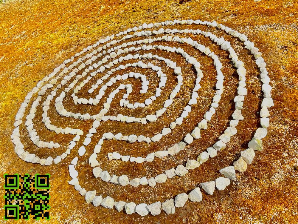 Close-up of labyrinth made from chalk stones on a moss-covered car park.