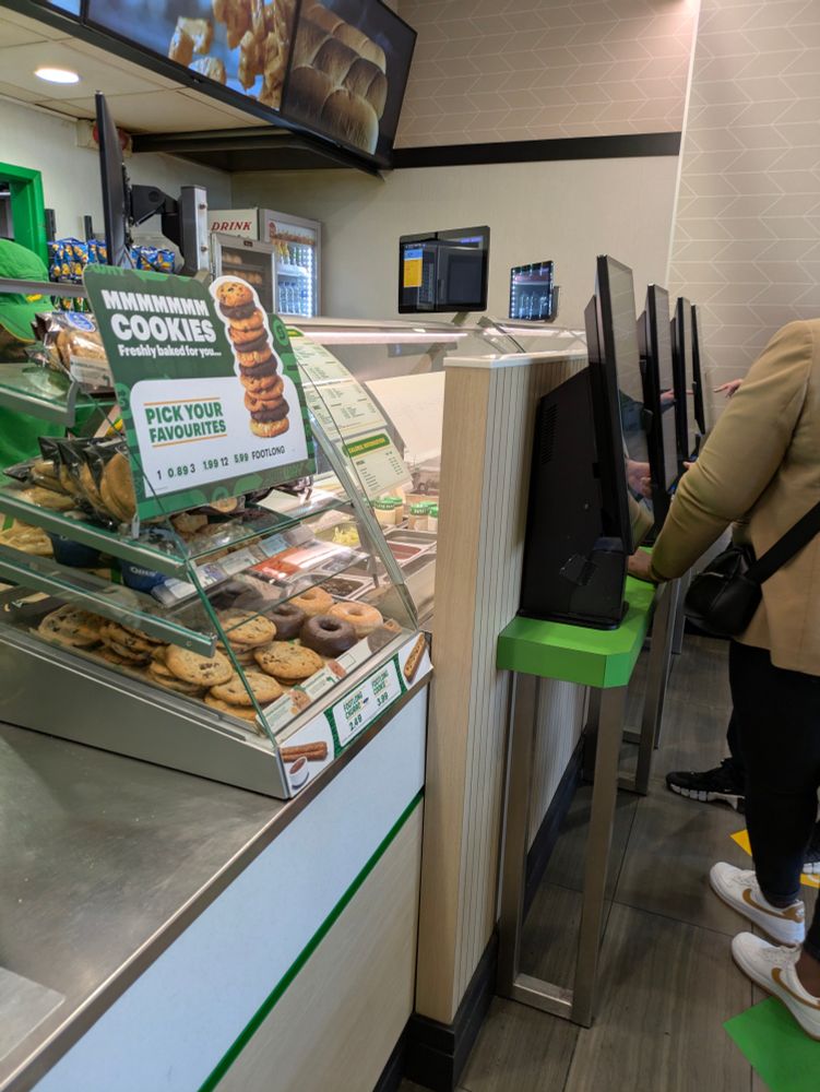 The new counter at Subway where they've blocked the view of the food preparation counter with ordering machines