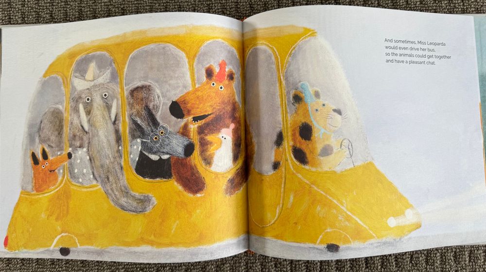 Page shows the leopard driving a full yellow bus again. Text reads: “And sometimes, Miss Leoparda would even drive her bus, so the animals could get together and have a pleasant chat.”