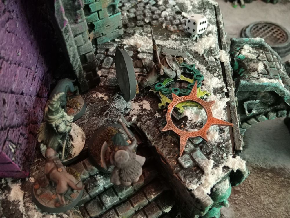close up of aftermath of a battle against a wraith knight, miniature with big axe lays flat