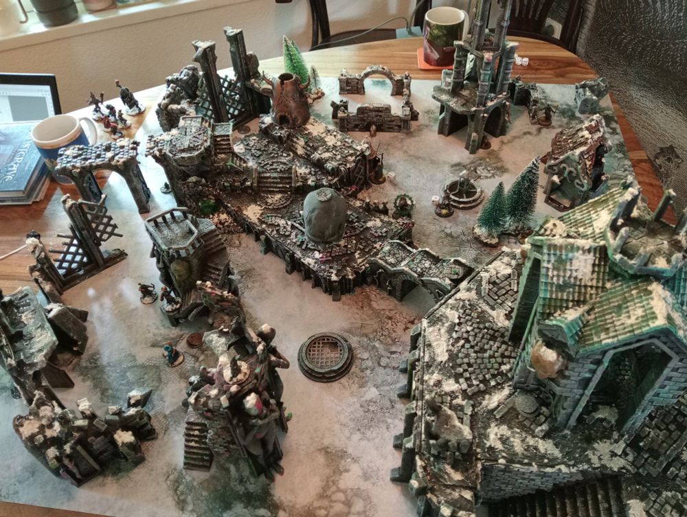 table filled with home made frostgrave terrain
