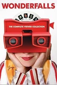 A femme person is looking through a Viewfinder, wearing red lipstick and wearing a white jogging suit and red stripes 