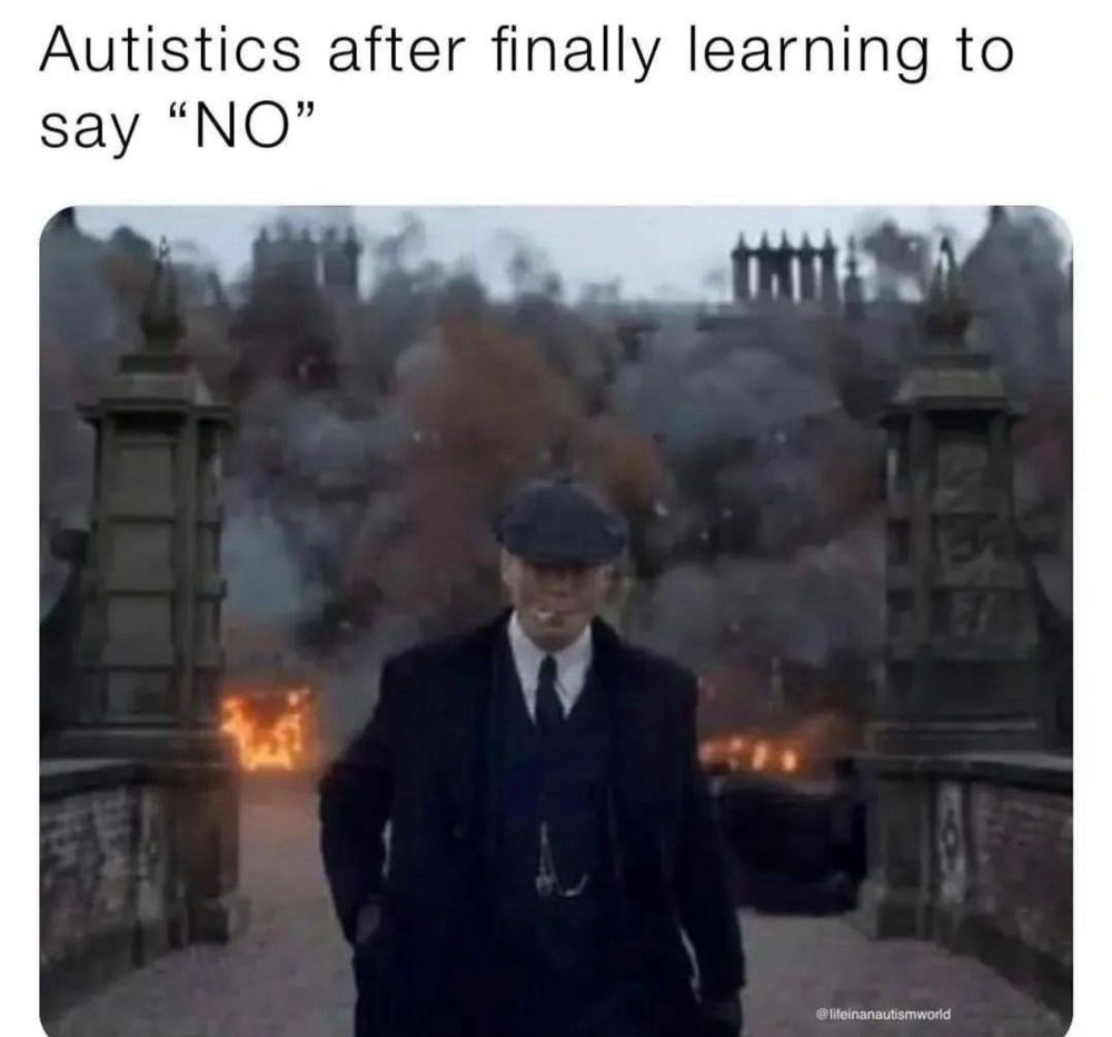 Cillian Murphy casually walking away from a city in burning ruins