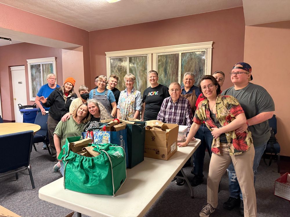 Members of the Portland Lesbian Choir pose with sack lunches which will be donated to Transition Projects. 