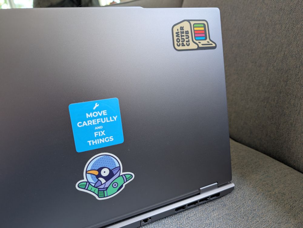 A new laptop with a "COMPUTER CLUB" sticker on the corner of its cover. The sticker is (I think!) almost indistinguishable from the originals.