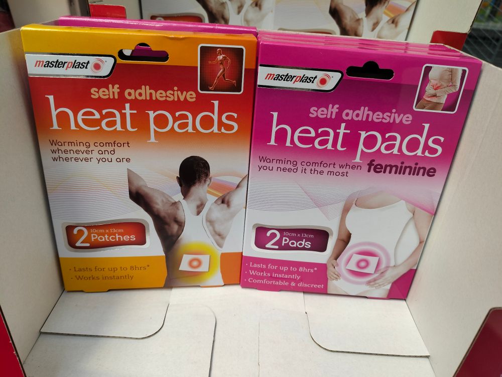 Packs of heat pads in a box. Despite being the same product, one pack is advertised as feminine.