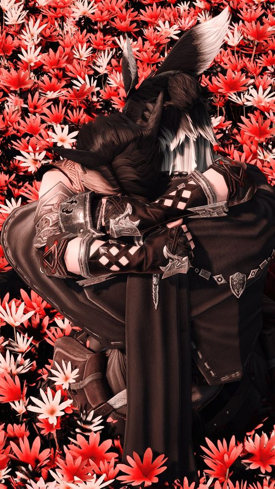 Ren and Leo hold each other in a tight embrace as they sit in a field of red and pink flowers. The sunset out of view leaves the atmosphere covered in a soft, comforting glow.