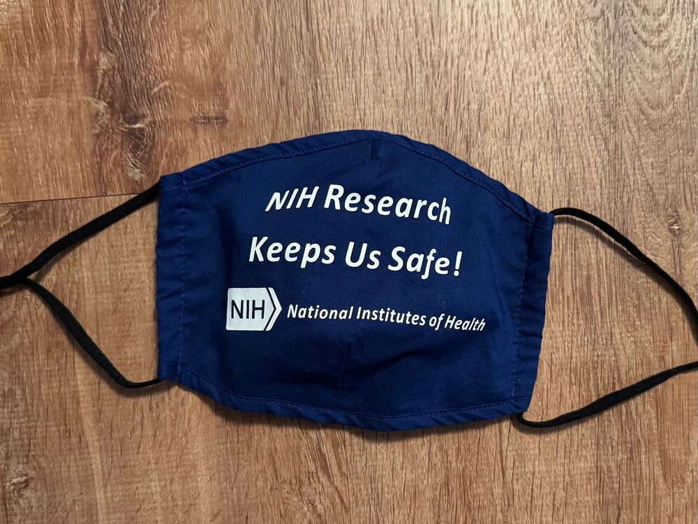 Face mask printed with text “NIH Research Keeps Us Safe!” and NIH logo