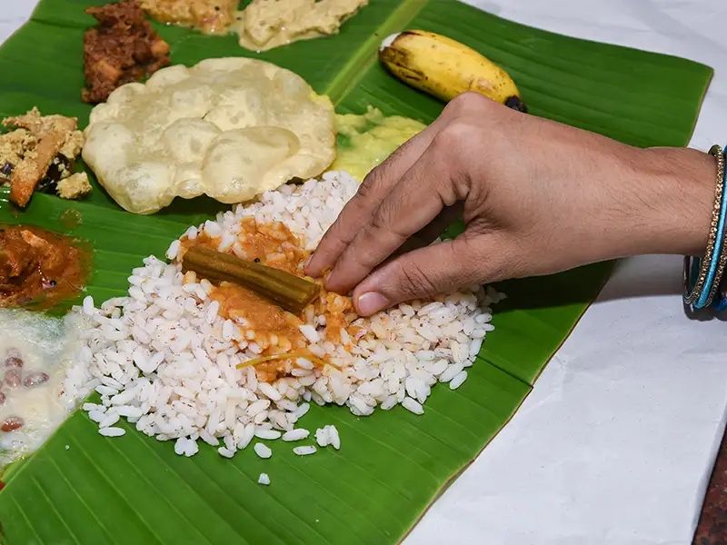 Eating with your hands off of banana leaves.