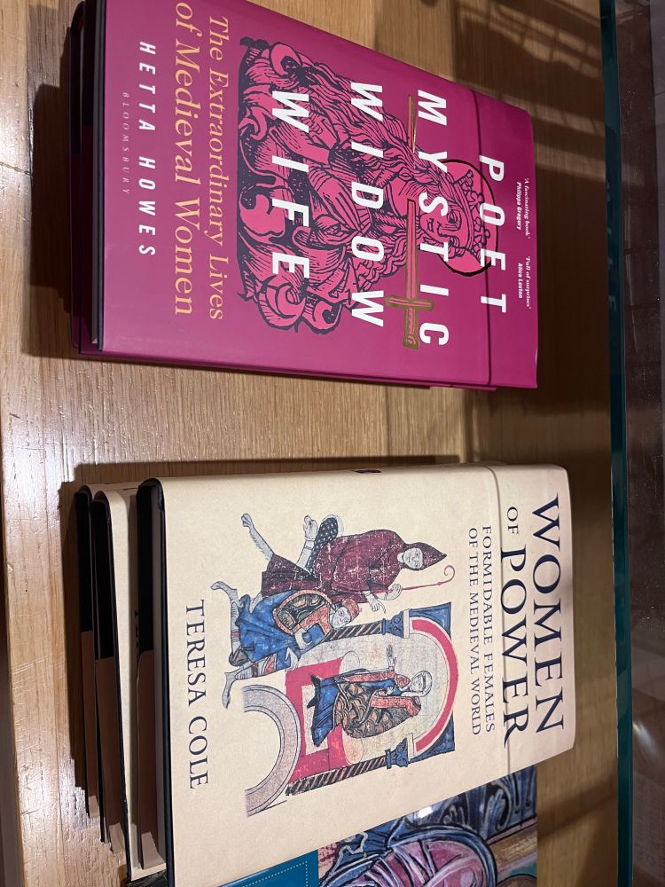 Two books about mediaeval women on bookshop a shelf. Poet, Mystic, Widow Wife and women of Power. 