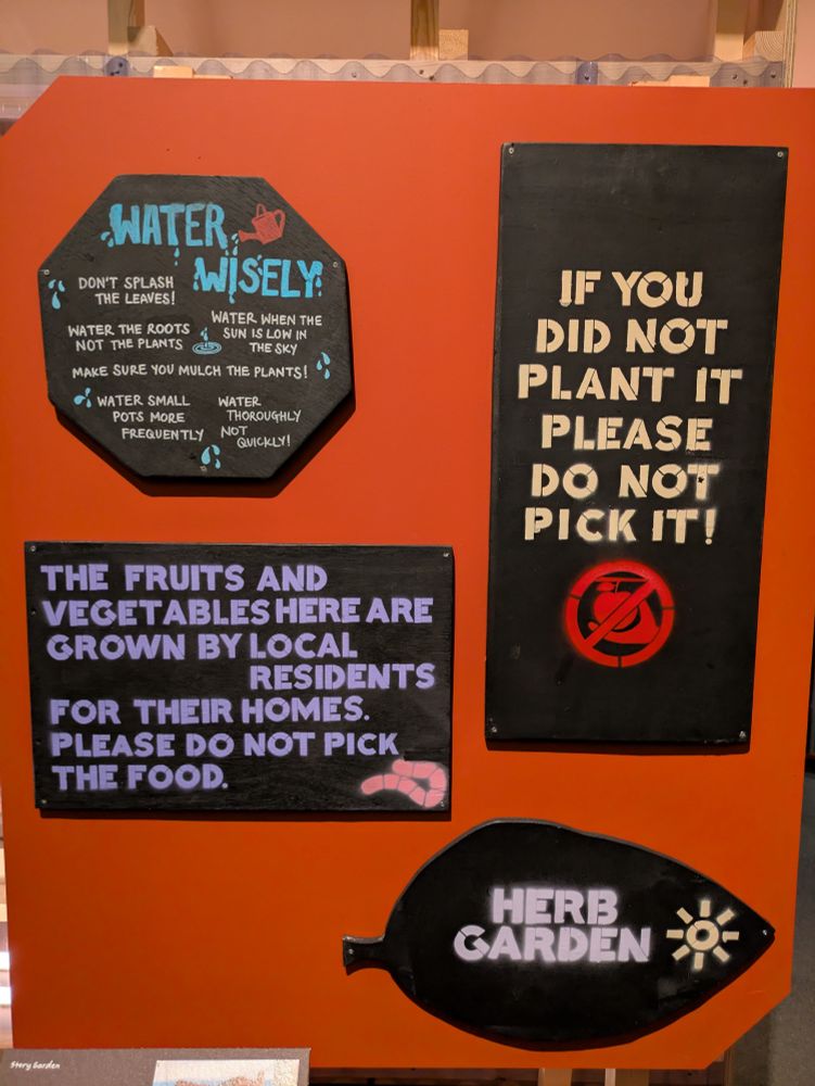 Signs from the British Library's story garden which was adapted from a disused parking lot. It is soon going to be developed to expand the BL, a new garden is apparently opening somewhere else. The signs say "water wisely" "if you did not plant it please do not pick it" "herb garden" and "the fruits and vegetables here are grown by local residents for their homes please do not pick the food."